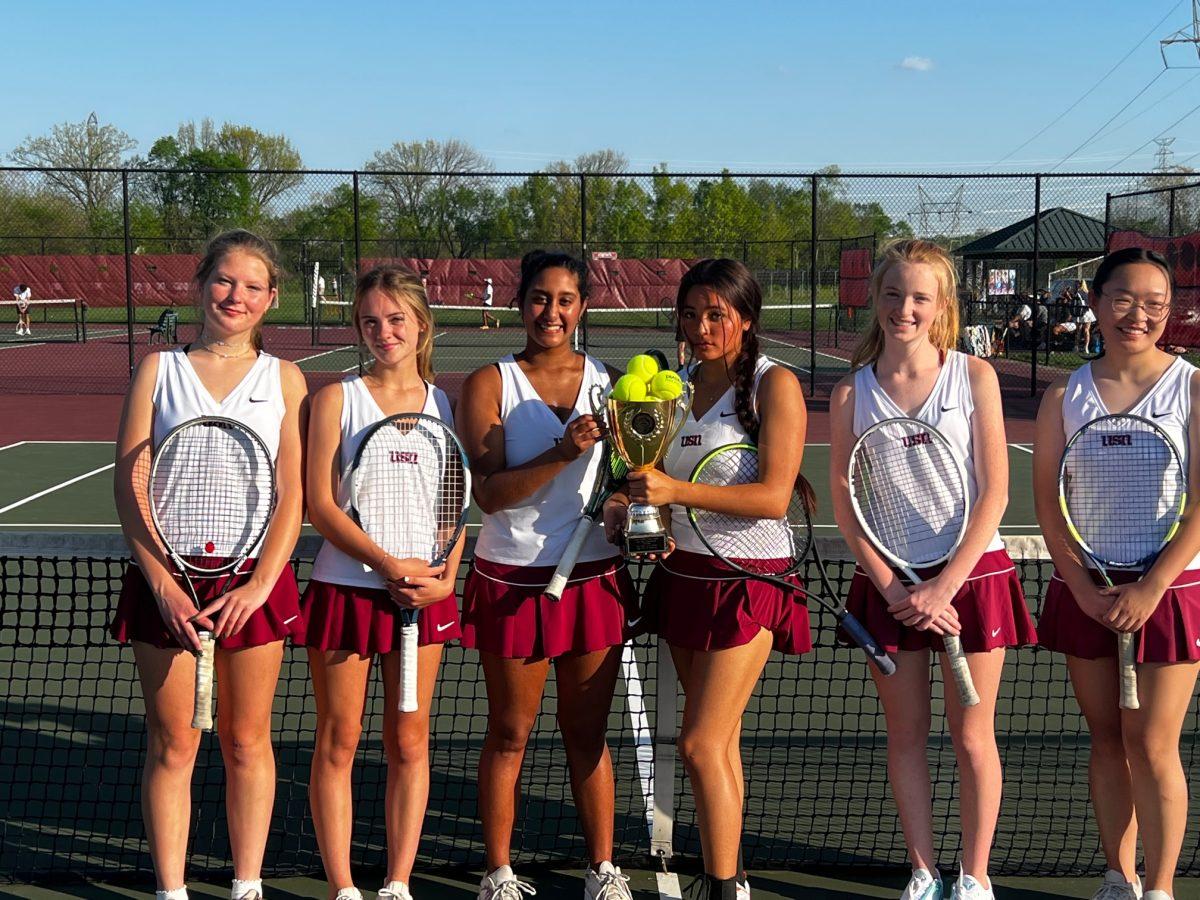 the 2022 girls' tennis team with the district championship trophy
