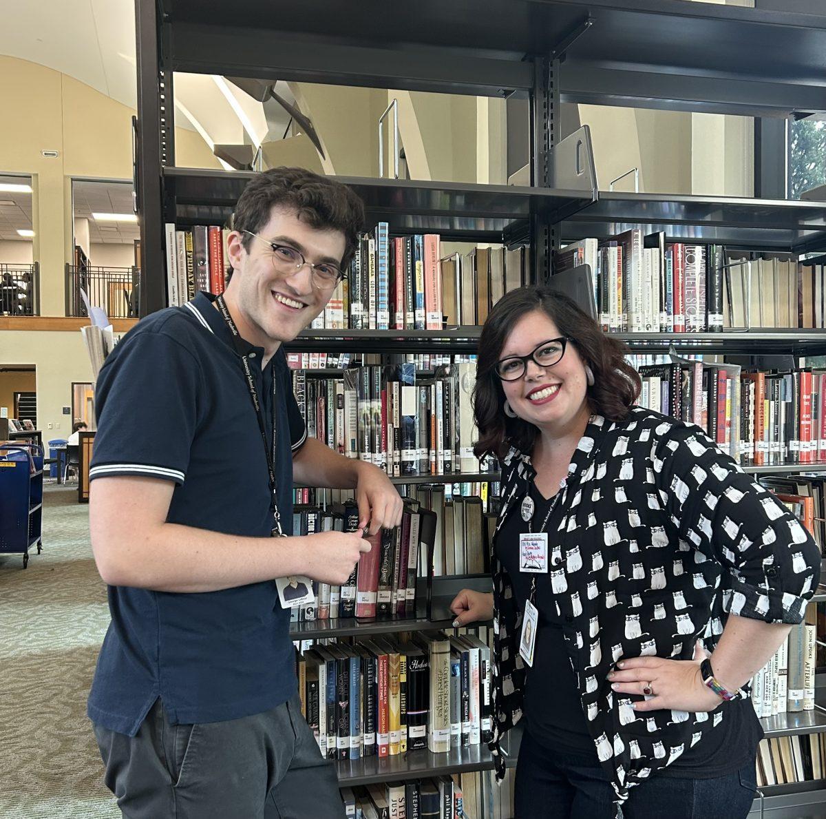 LaBour and Brown strike a pose in the Hassenfeld Library stacks (via the Peabody Press)