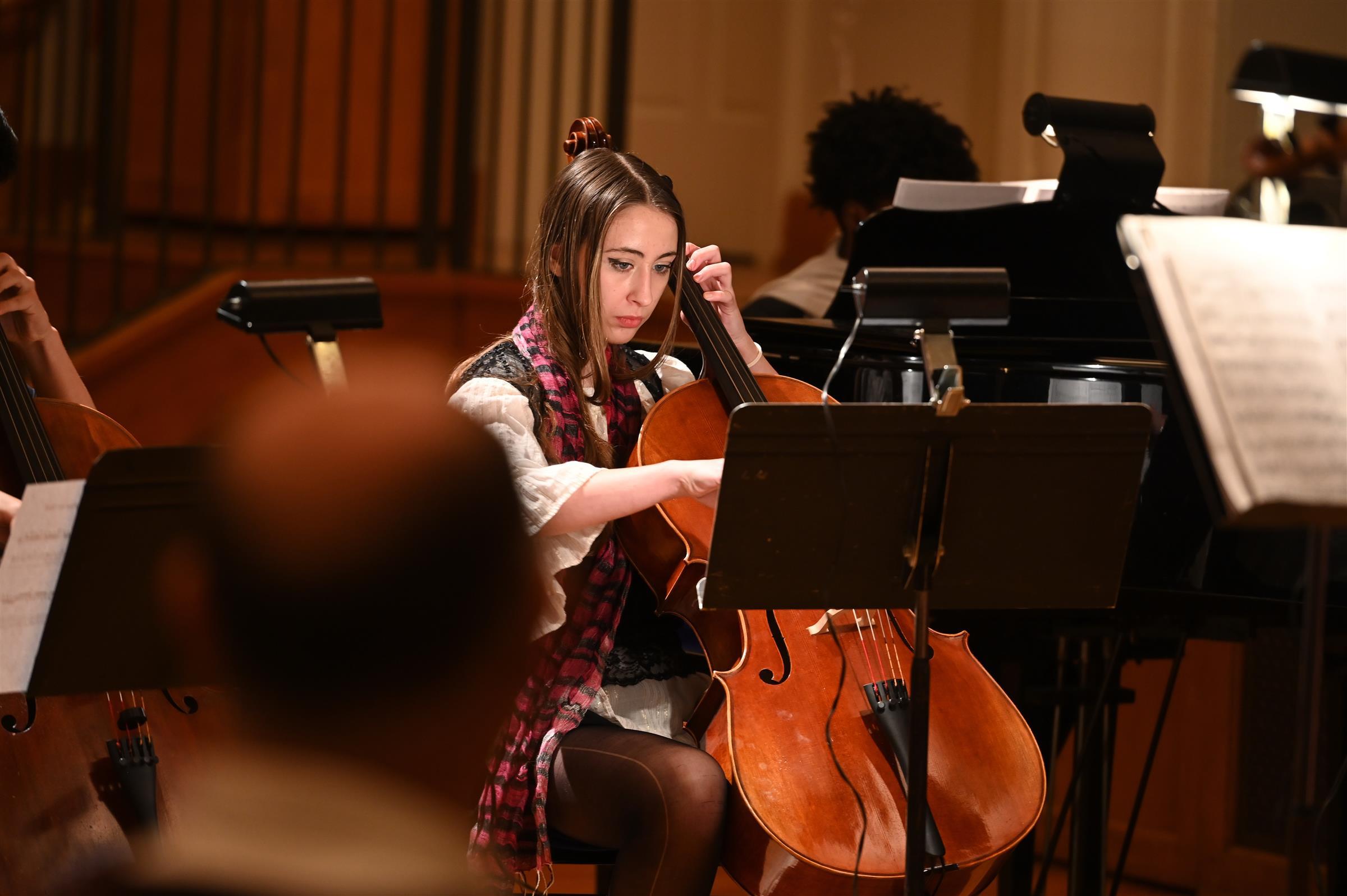 Natalie Mallal '24 focuses on her cello playing during last year's Classical Night set with the Chamber Ensemble (via usn.org).