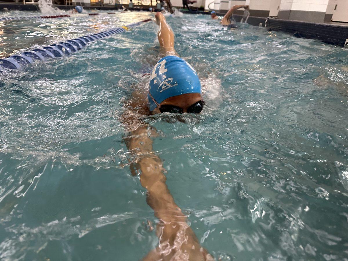Kailyn Womer ‘24 glides into the end of her lap at practice. (via the Peabody Press)
