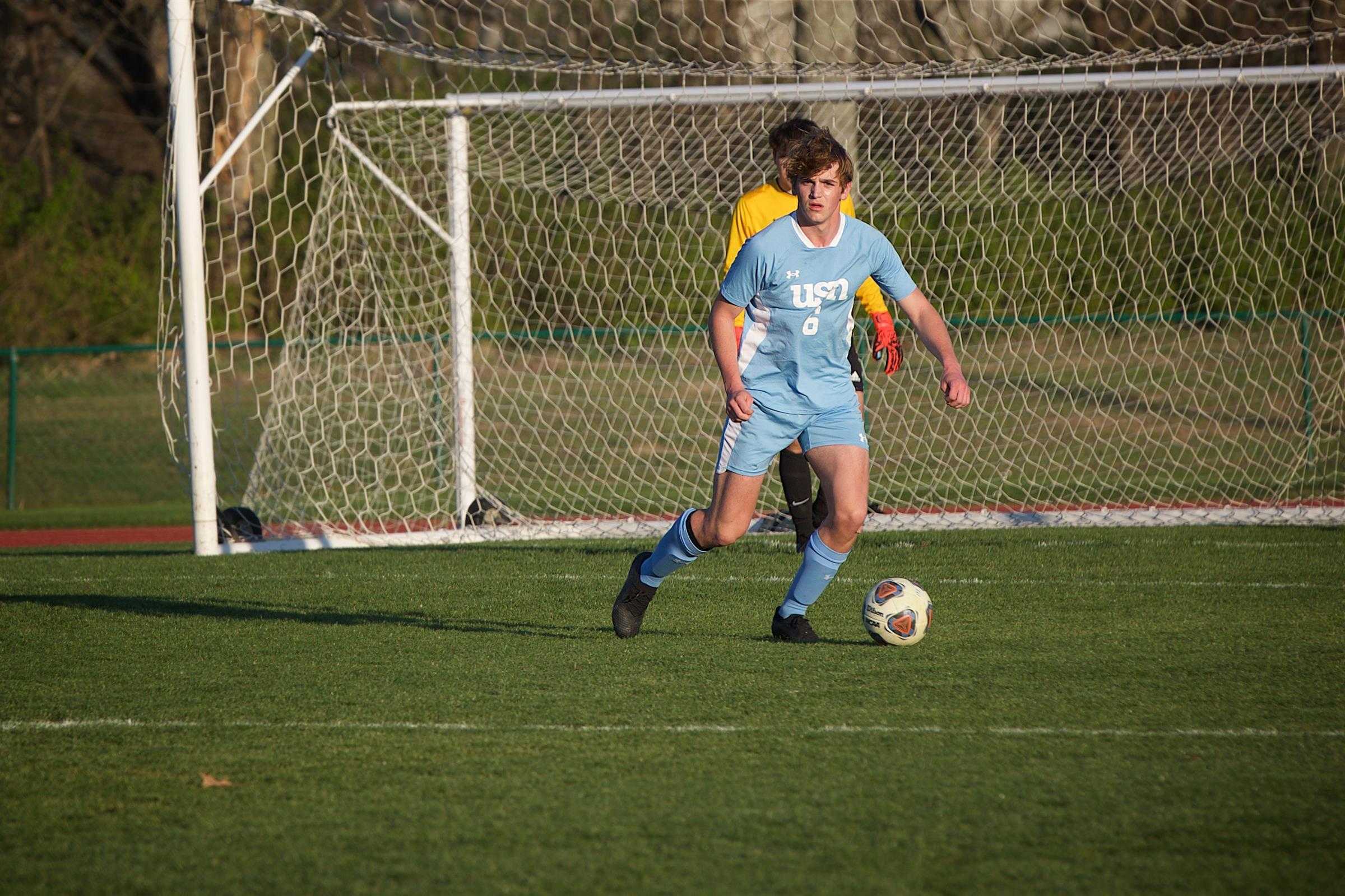 BALLING OUT:  Mark Luschen ‘24 dribbles in a game during the 2023 season. (via Kimberly Manz)