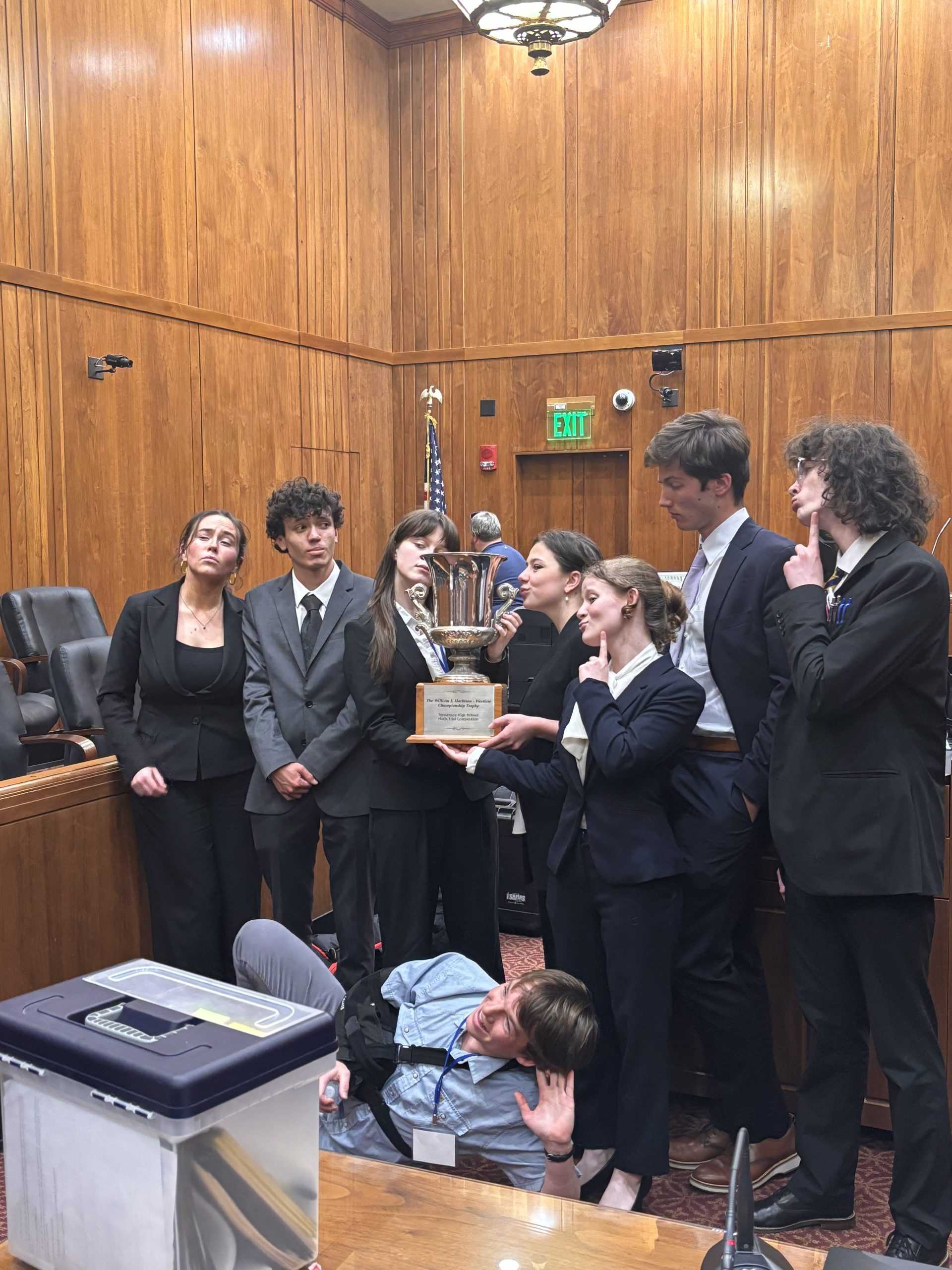 Clockwise from left: Caroline Quinones '24, Xavier Warren '24, Erin Joyce '25, Margot Ross '25, Ophelia Cherry-Pulay '25, Benjamin Kampine '25, Bronson Schmidt '25 and Henry Gatto '25 -- celebrate with their state championship trophy (via Wilson Hubbell).