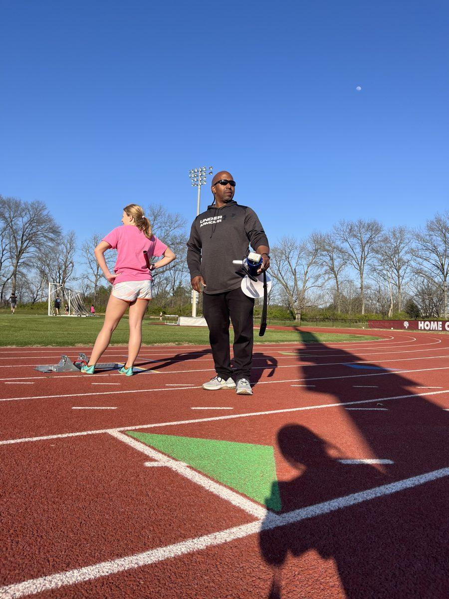 Coach Hill at a track practice with megaphone in hand (via the Peabody Press).