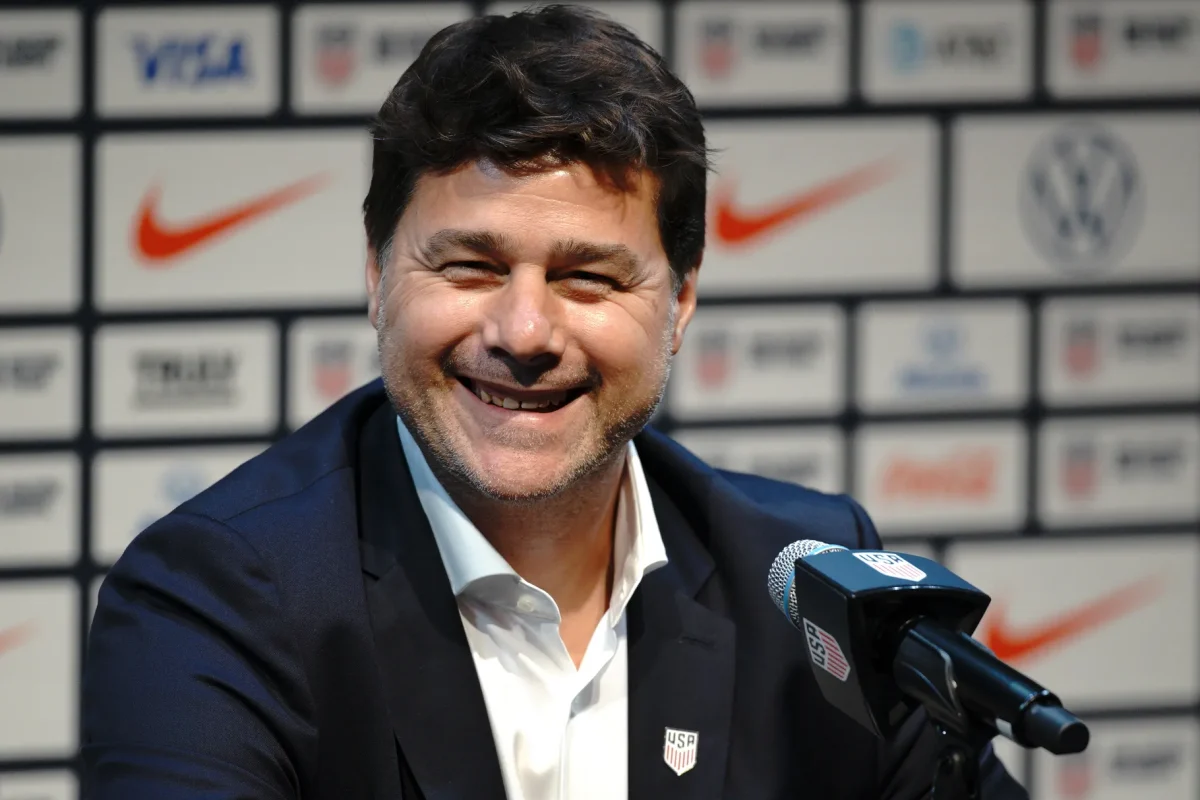Pochinetto at a press conference sporting the USA soccer lapel pin (via Evan Bernstein/Getty Images).