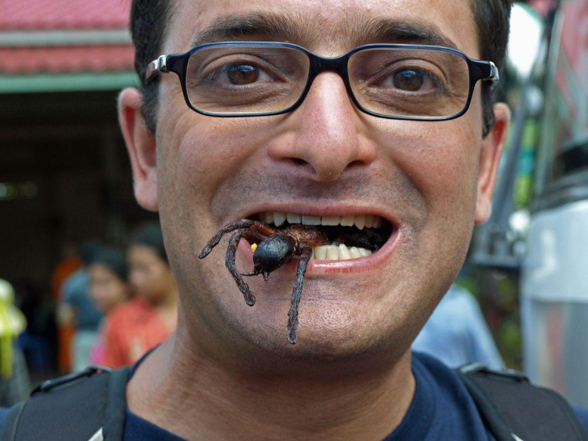 Caption: Blogger Matt Gross eats a fried spider in Southeast Asia. (via Matt Klein)
