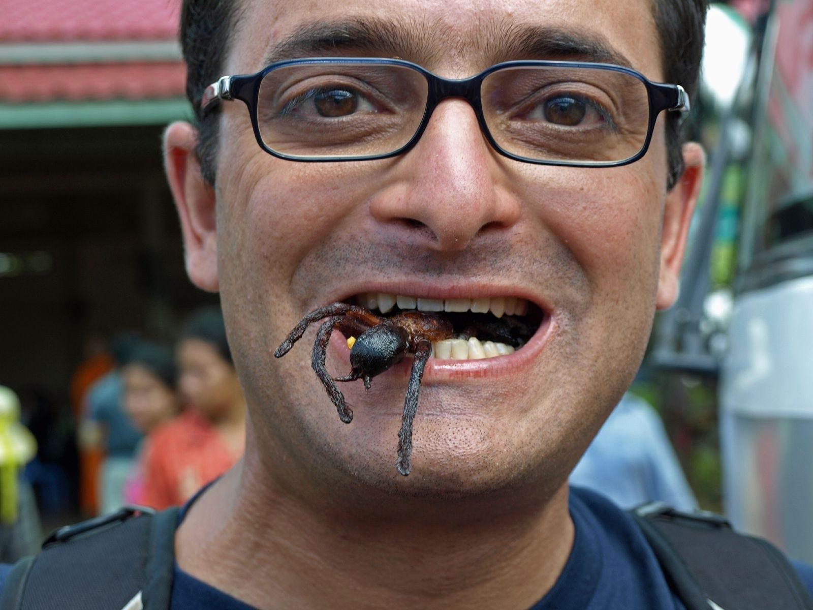 Caption: Blogger Matt Gross eats a fried spider in Southeast Asia. (via Matt Klein)
