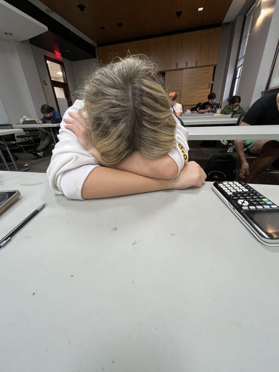 A student takes a moment of rest after taking an exam. (via the Peabody Press)