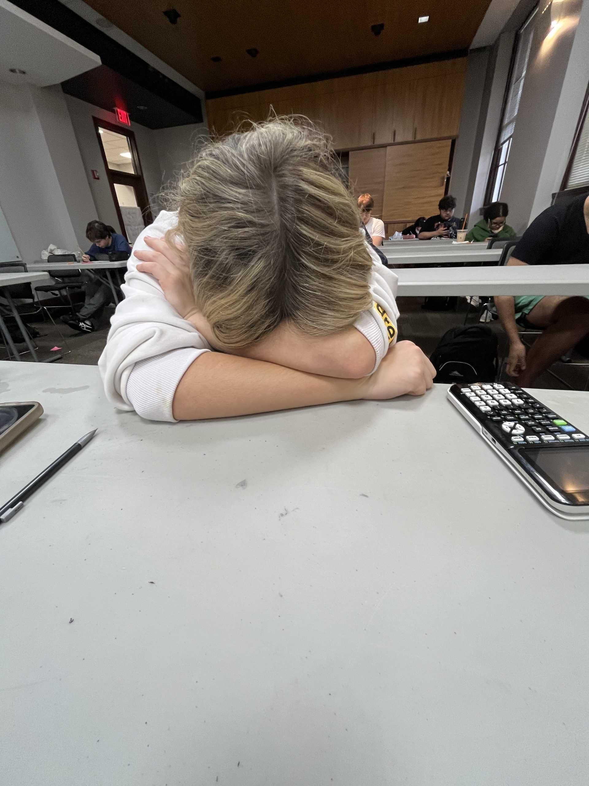A student takes a moment of rest after taking an exam. (via the Peabody Press)