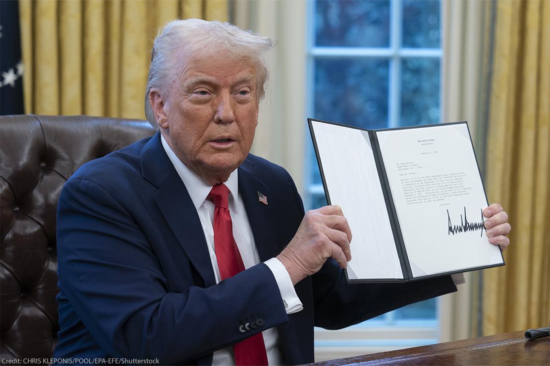 Trump signs an executive order in the Oval Office (via Chris Kleoponis / Shutterstock).