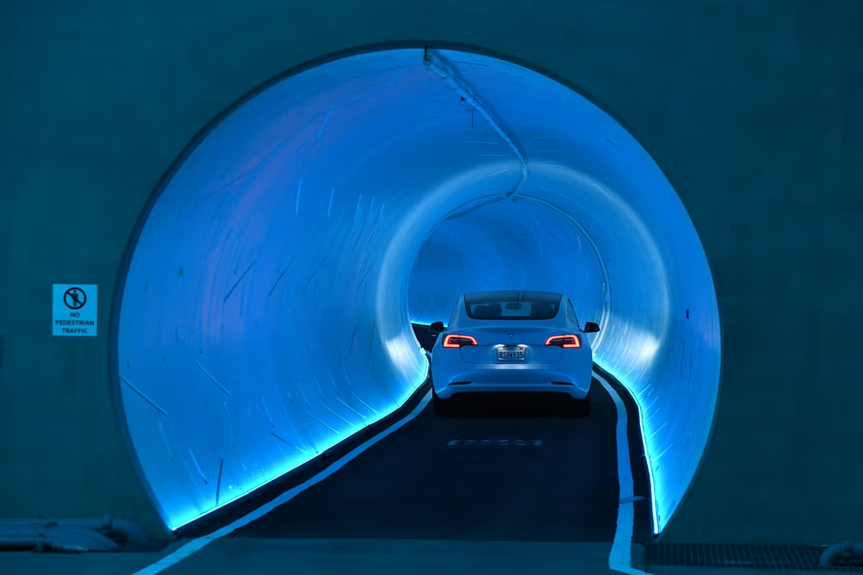 NOT SO BORING AFTER ALL: A Tesla drives through a colorful tunnel in Las Vegas. (via Ethan Miller, Getty Images)
