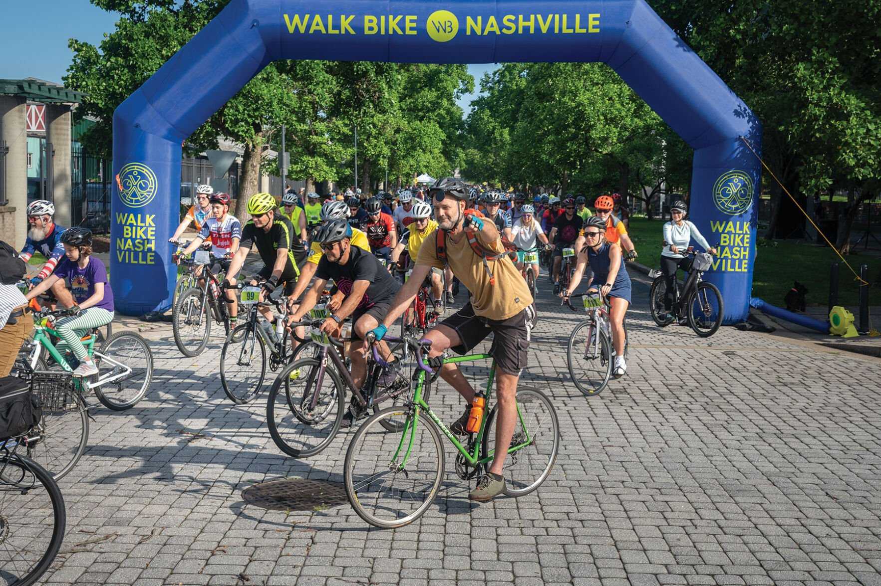  A happy cyclist points to the camera at a Walk Bike Nashville event. (via Eric England)
