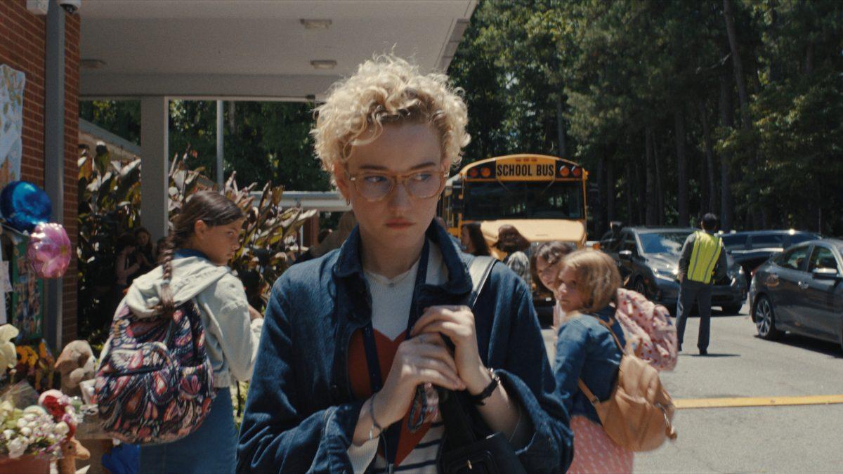 Justine Grandy walks wearily by Maybrook Elementary. (via Warner Bros.)