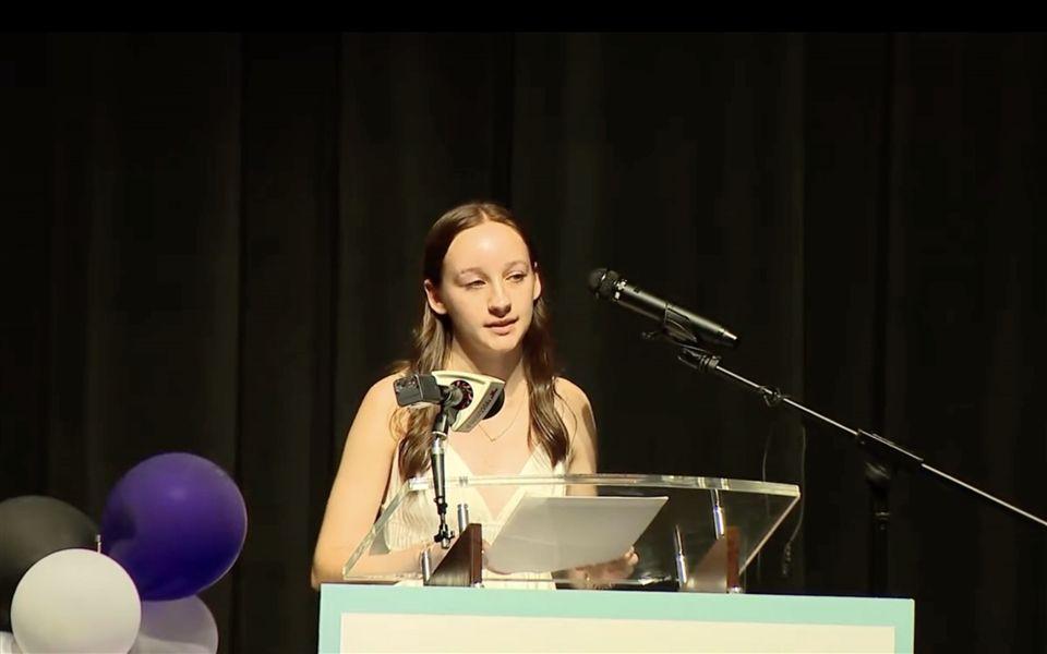 Breckyn Forcey ’26 delivers her poem “The Empire Eats Itself” during a town hall in August. (via usn.org)