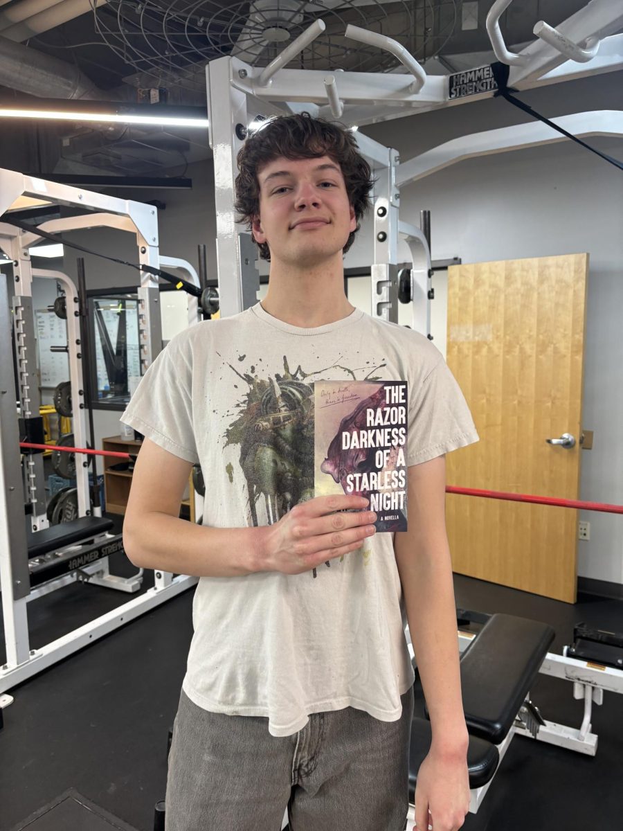 Brandon shows off his new novella in the USN Fitness Center. (via the Peabody Press)