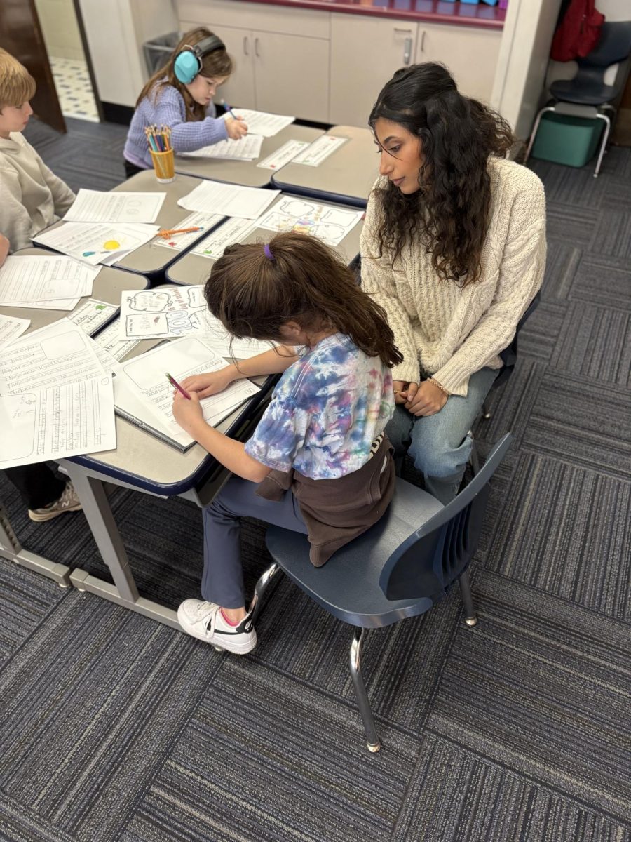 Divya Rao '26 works with Lizzie Hall's first graders as part of the Lower School teaching assistant program. (via the Peabody Press)