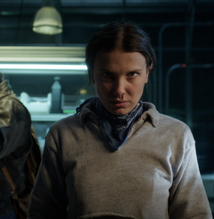Eleven, played by Millie Bobby Brown, uses her powers against the military in the upside down version of the Hawkins Lab (via Netflix).
