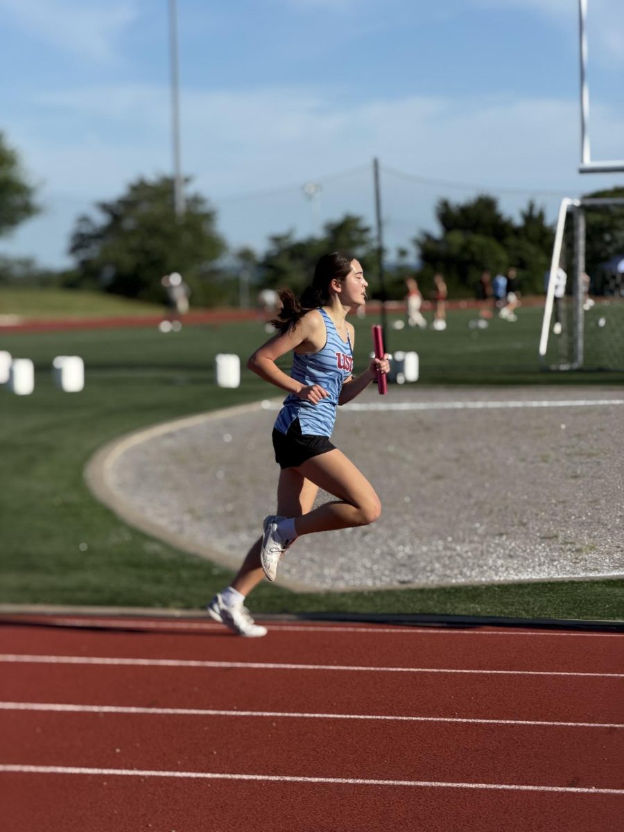 Madeleine Wiseman '27 runs her leg of the 4x800 relay at track regionals
