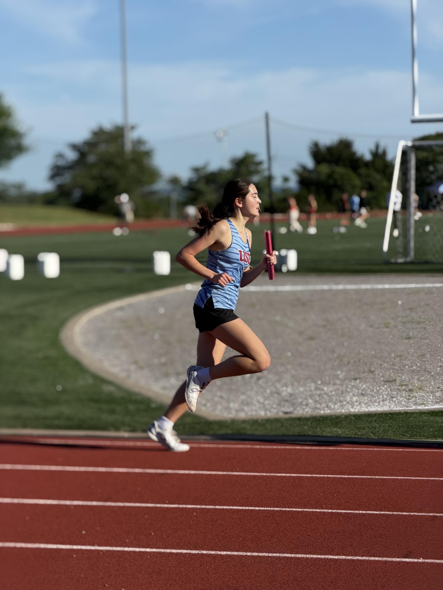 Madeleine Wiseman '27 runs her leg of the 4x800 relay at track regionals