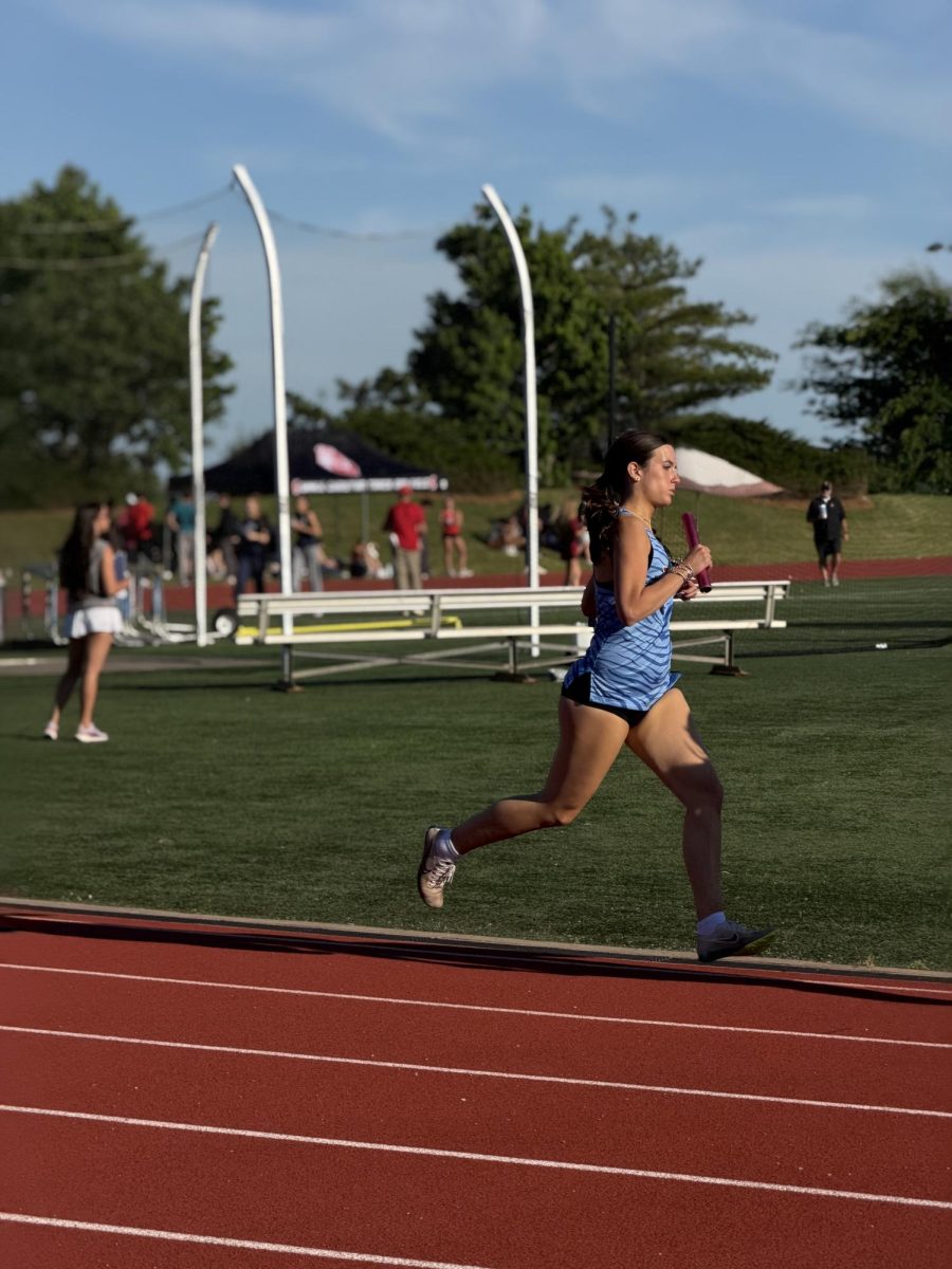 Norah Harrison '27 runs her leg of the 4x800 relay at track regionals