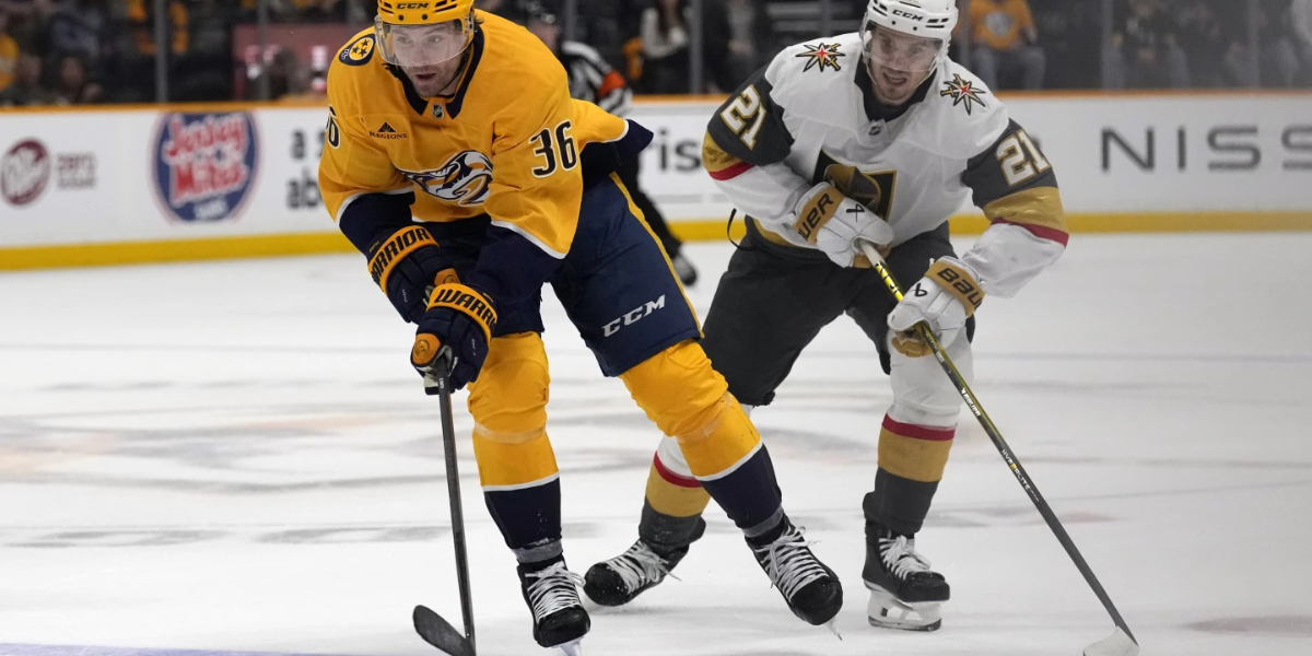 Two players engaged in a race to the puck (photo via Inside the Rink)