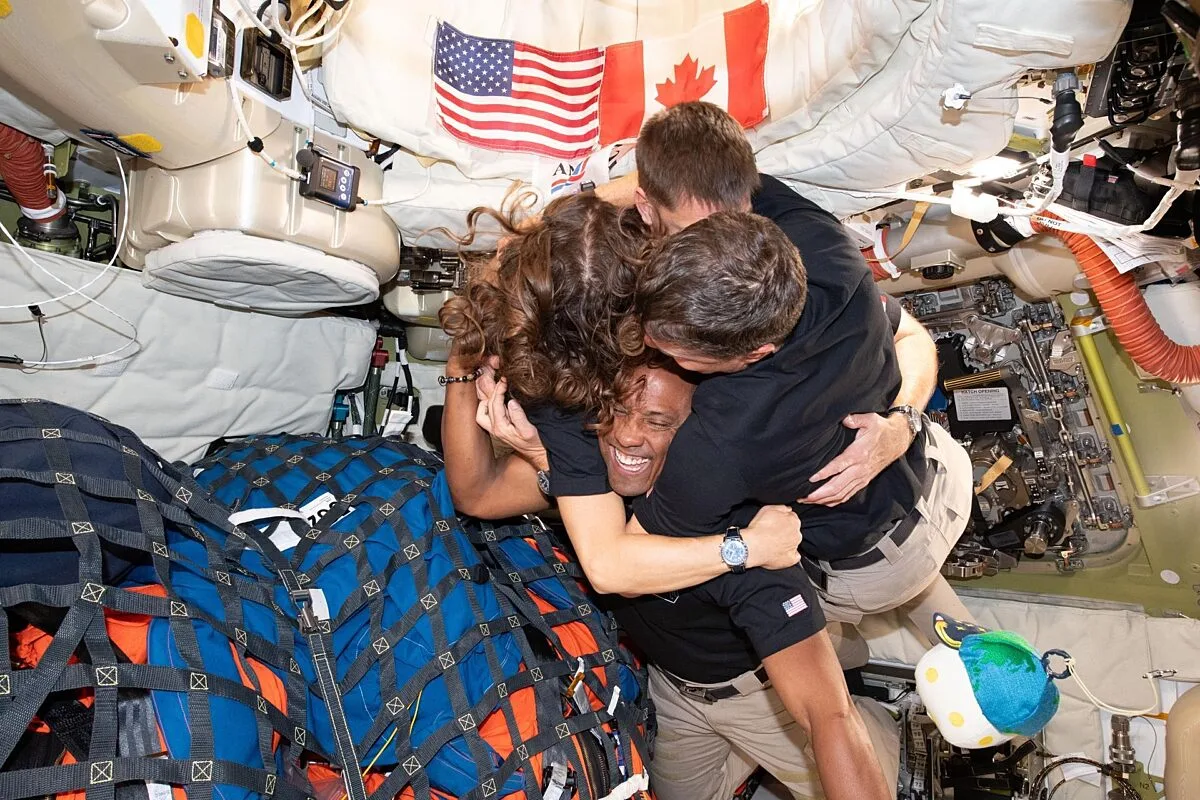 Nasa astronauts embrace over the lunar surface. (via NASA.gov)